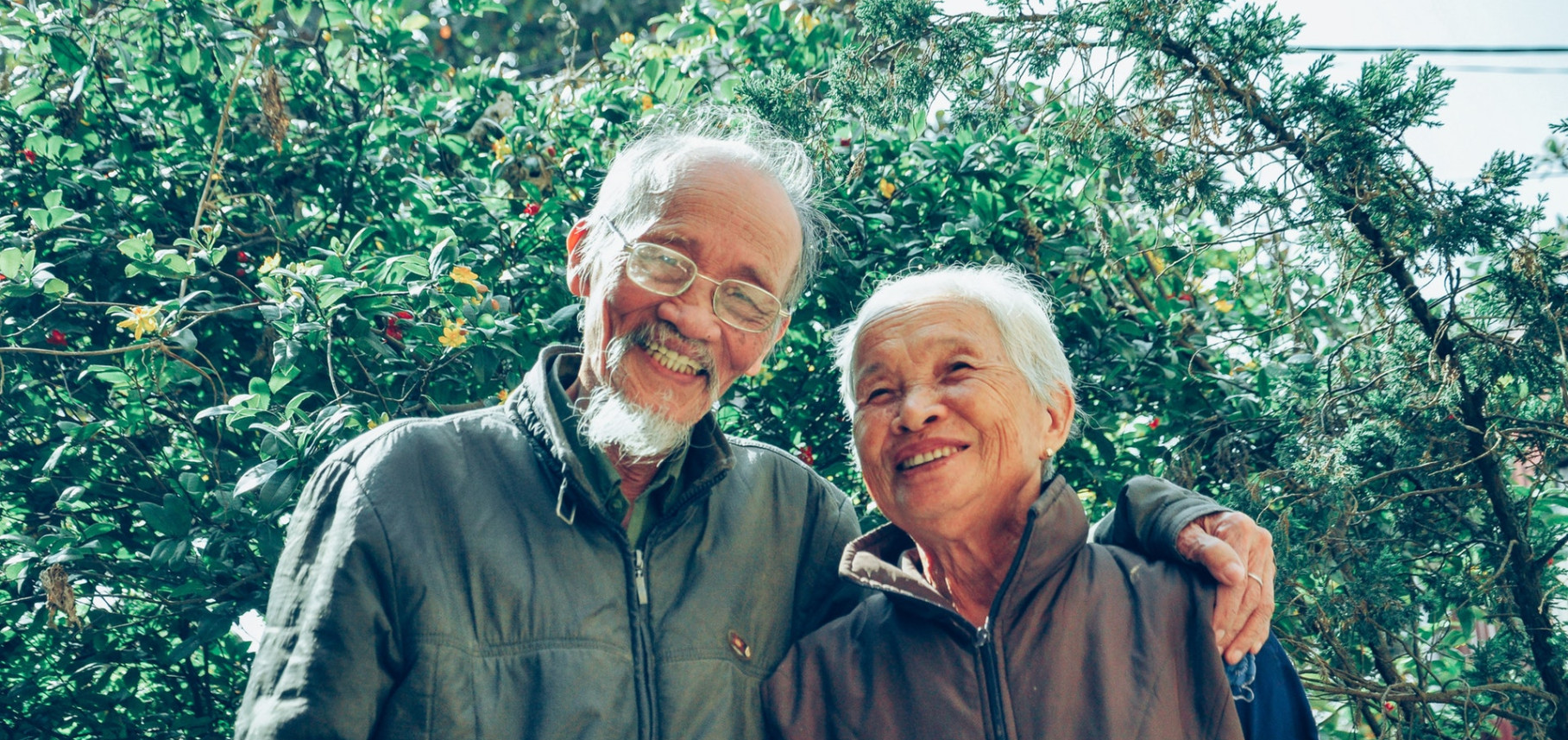 smiling man and woman wearing jackets 1642883 2